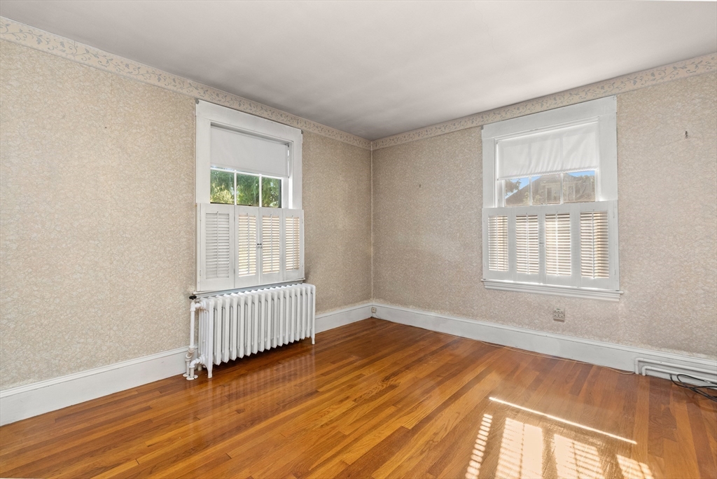 25 High Street Beverly, MA 01915 - Photo 25 of 42 a view of an empty room with wooden floor and a window