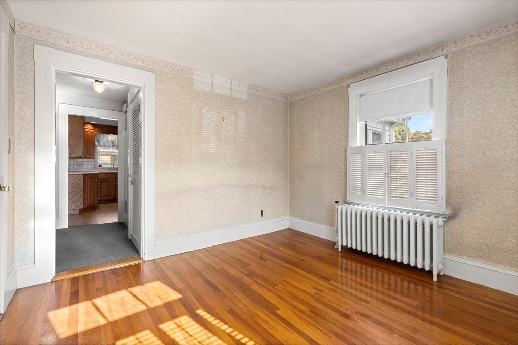 25 High Street Beverly, MA 01915 - Photo 26 of 42 an empty room with wooden floor and windows