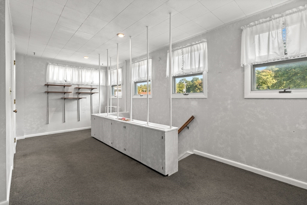 25 High Street Beverly, MA 01915 - Photo 33 of 42 a kitchen with stainless steel appliances a refrigerator and a stove top oven