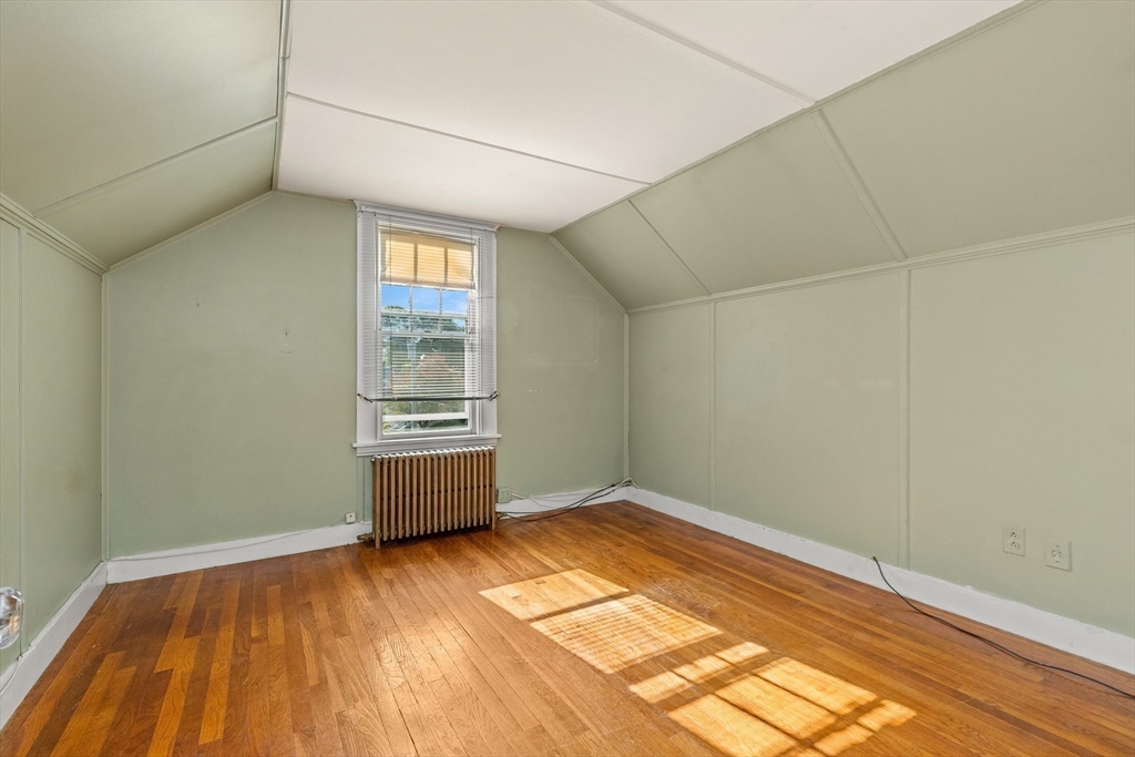 25 High Street Beverly, MA 01915 - Photo 37 of 42 a view of an empty room with wooden floor and a window