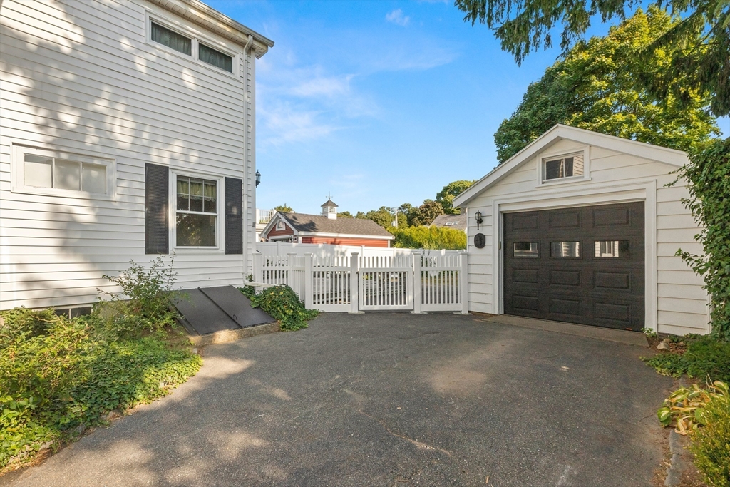 25 High Street Beverly, MA 01915 - Photo 42 of 42 a front view of a house with a yard and garage