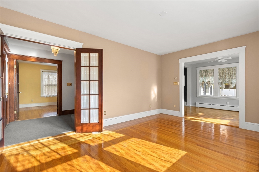 25 High Street Beverly, MA 01915 - Photo 5 of 42 a view of an empty room with wooden floor and a window