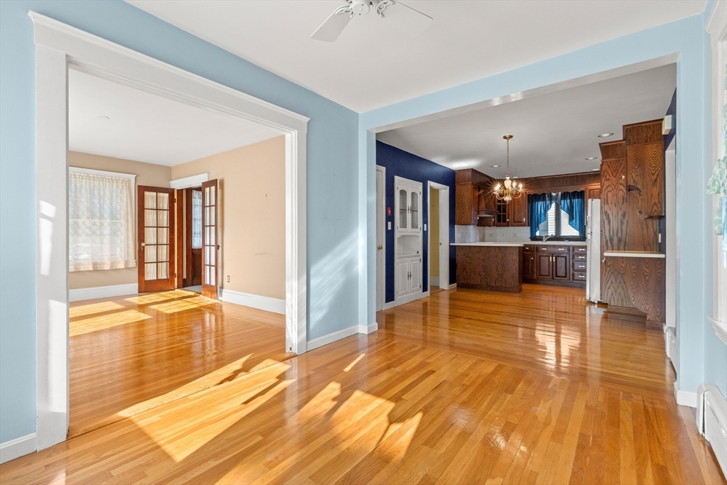 25 High Street Beverly, MA 01915 - Photo 8 of 42 a big room with wooden floor and windows