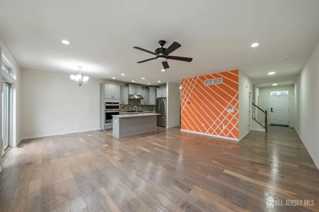 a kitchen with kitchen island a counter top space cabinets and stainless steel appliances