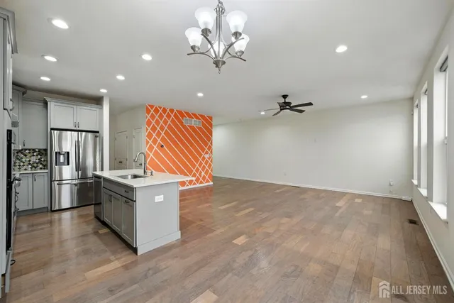 a kitchen with stainless steel appliances kitchen island granite countertop a sink and cabinets