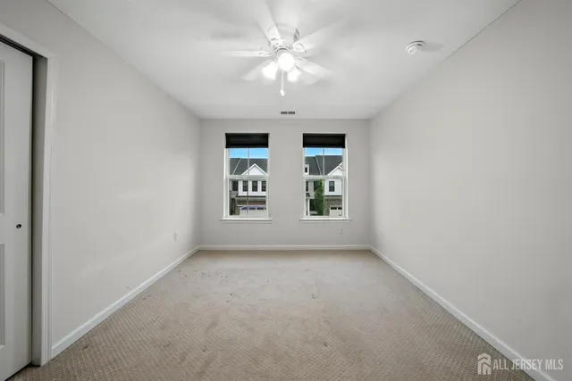 a bathroom with a sink vanity mirror and toilet