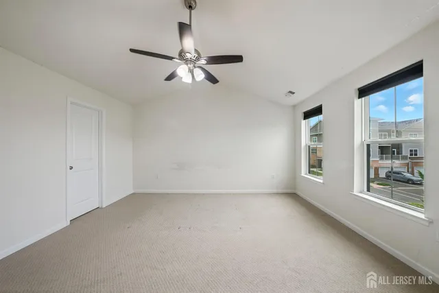 a view of a livingroom with a ceiling fan and window