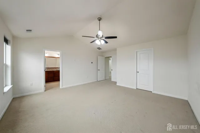 a bathroom with a granite countertop sink mirror and toilet