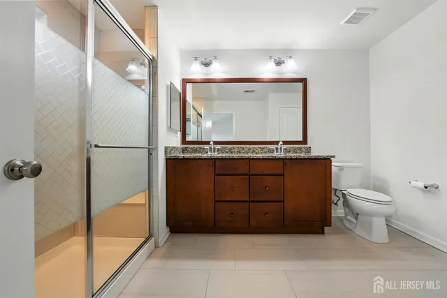 a view of a hallway with closet and stairs