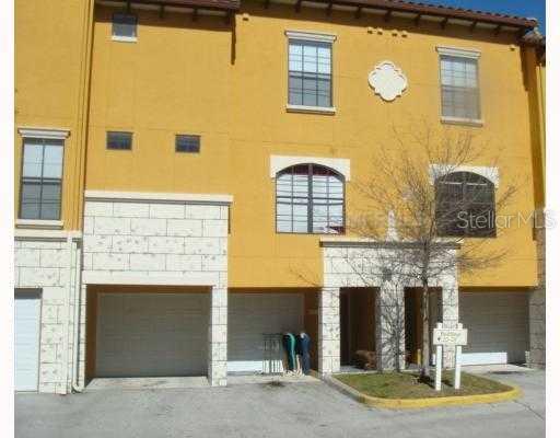 6135 Metrowest Boulevard, Unit 103 Orlando, FL 32835 - Photo 1 of 1 a front view of a house with a garage
