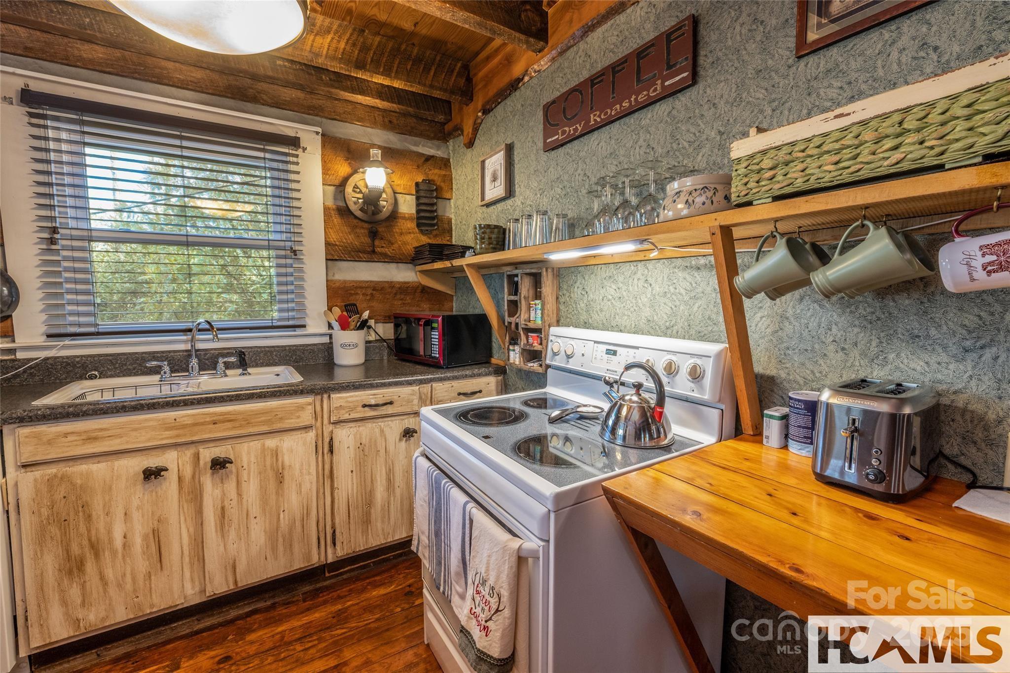 1524 McCall Road Cashiers, NC 28717 - Photo 11 of 35 a kitchen that has a sink and a stove