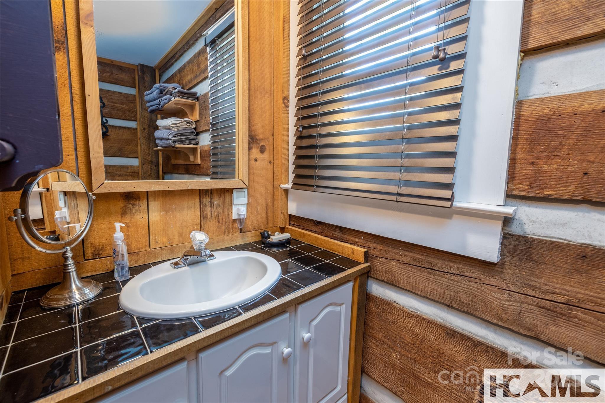 1524 McCall Road Cashiers, NC 28717 - Photo 15 of 35 a bathroom with a sink and a mirror