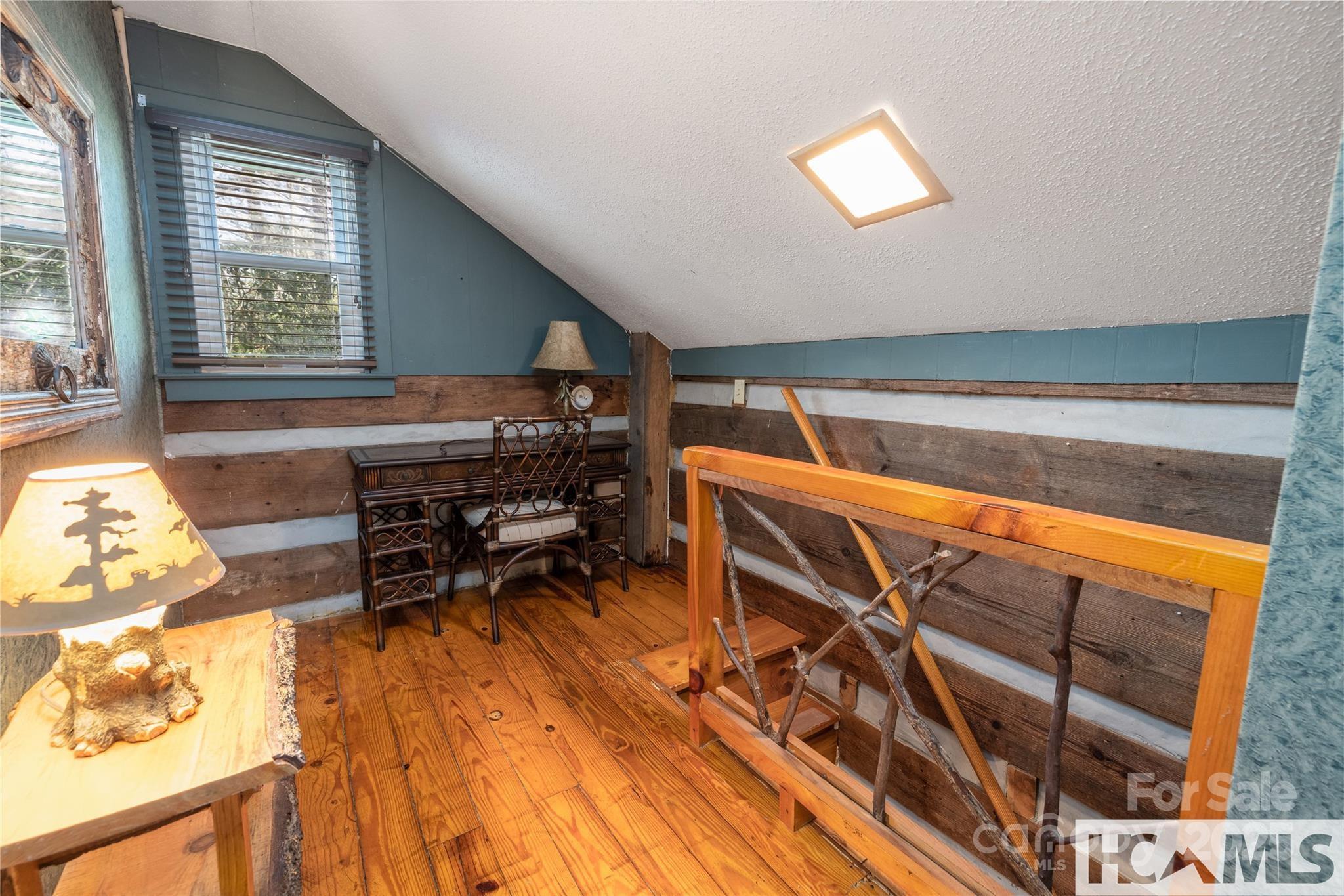1524 McCall Road Cashiers, NC 28717 - Photo 16 of 35 a bedroom with furniture and a window