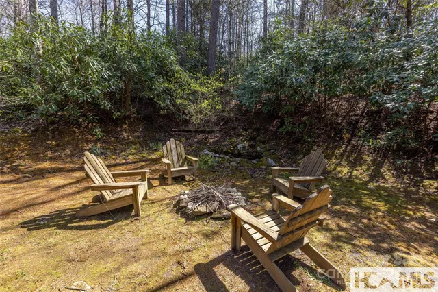 a wooden bench sitting in the middle of a yard