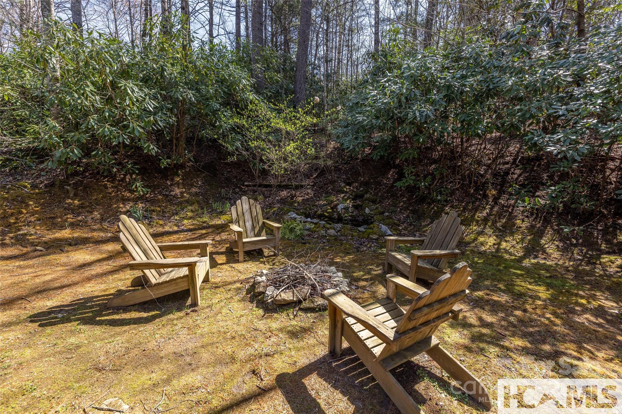 1524 McCall Road Cashiers, NC 28717 - Photo 20 of 35 a view of a lounge chair in the backyard