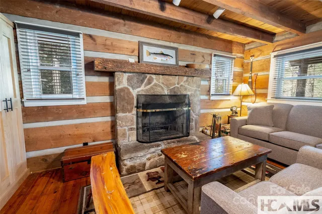 a living room with furniture a fireplace and wooden floor