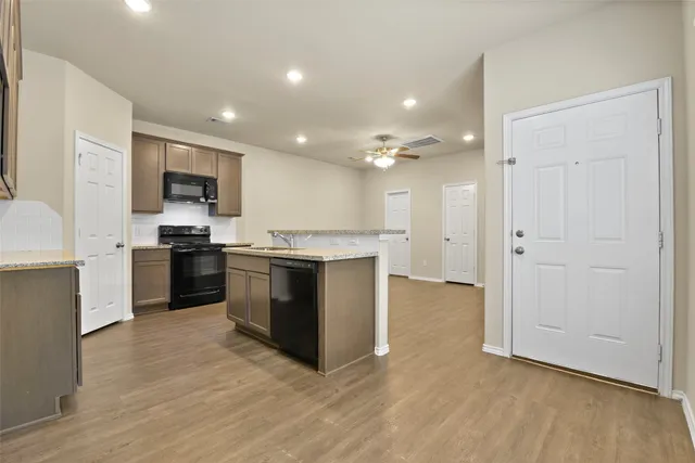 a view of kitchen with microwave and cabinets