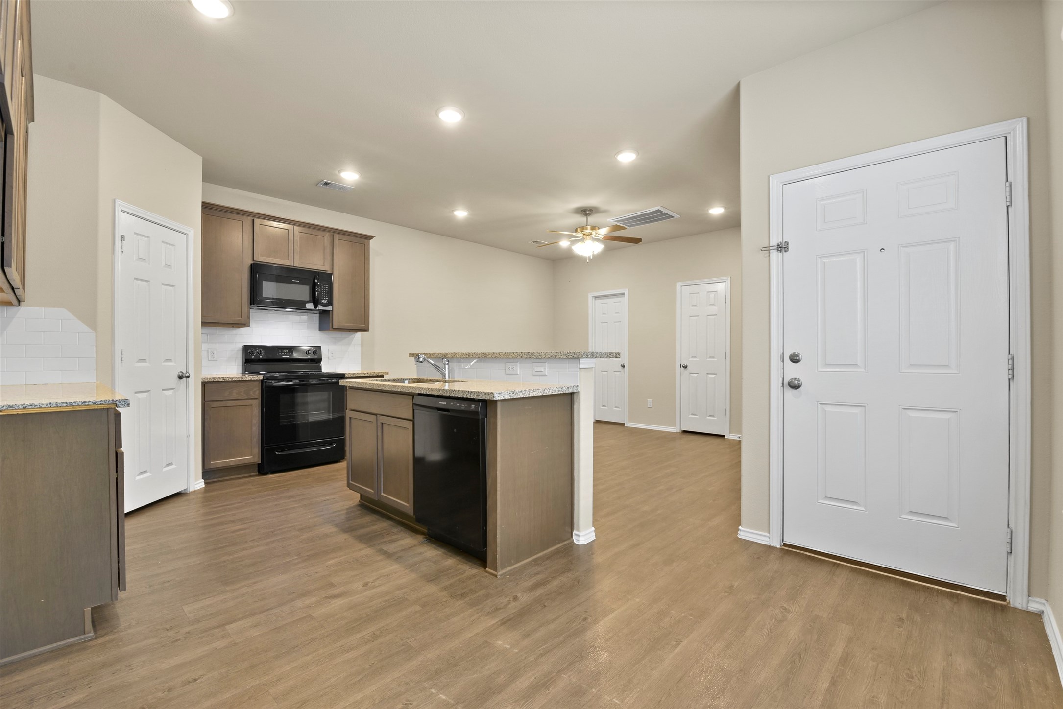 9650 Warm Spring Willis, TX 77318 - Photo 12 of 26 a kitchen with a sink and a stove top oven