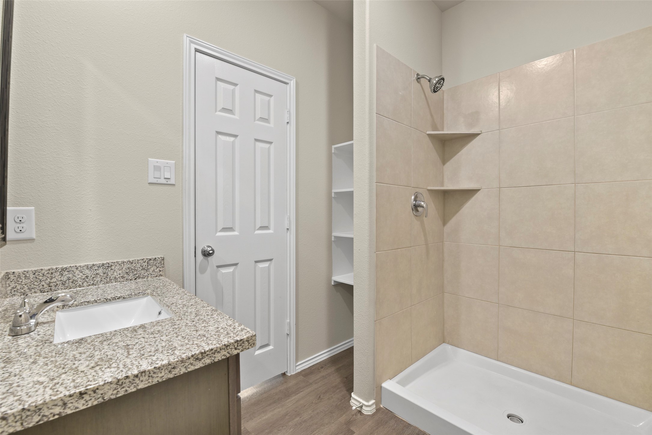 9650 Warm Spring Willis, TX 77318 - Photo 18 of 26 a bathroom with a granite countertop sink and shower