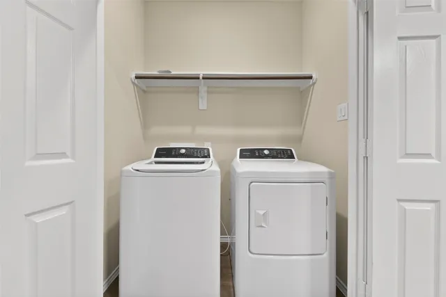 an empty room with wooden floor and ceiling fan