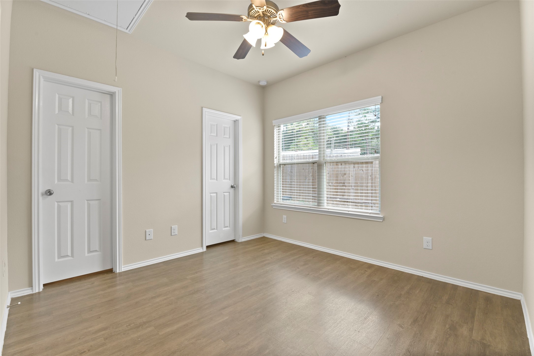 9650 Warm Spring Willis, TX 77318 - Photo 20 of 26 an empty room with chandelier fan and windows