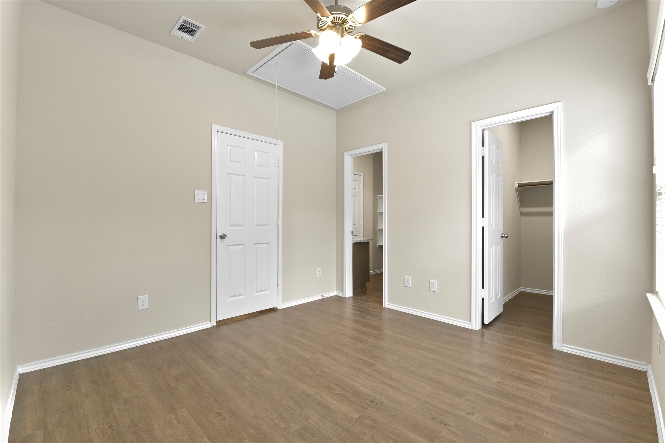 9650 Warm Spring Willis, TX 77318 - Photo 21 of 26 an empty room with wooden floor and ceiling fan