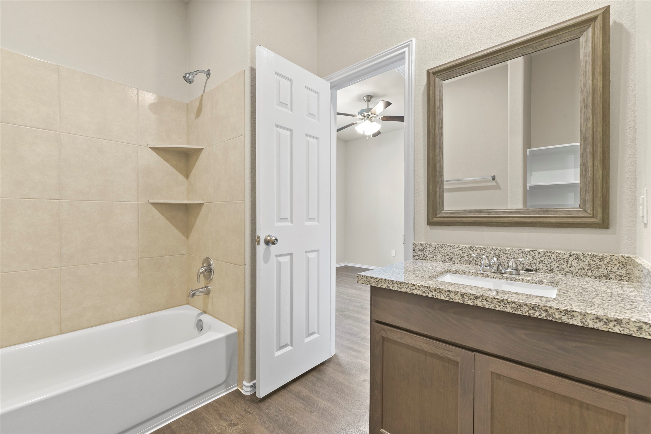 9650 Warm Spring Willis, TX 77318 - Photo 22 of 26 a bathroom with a tub sink and mirror