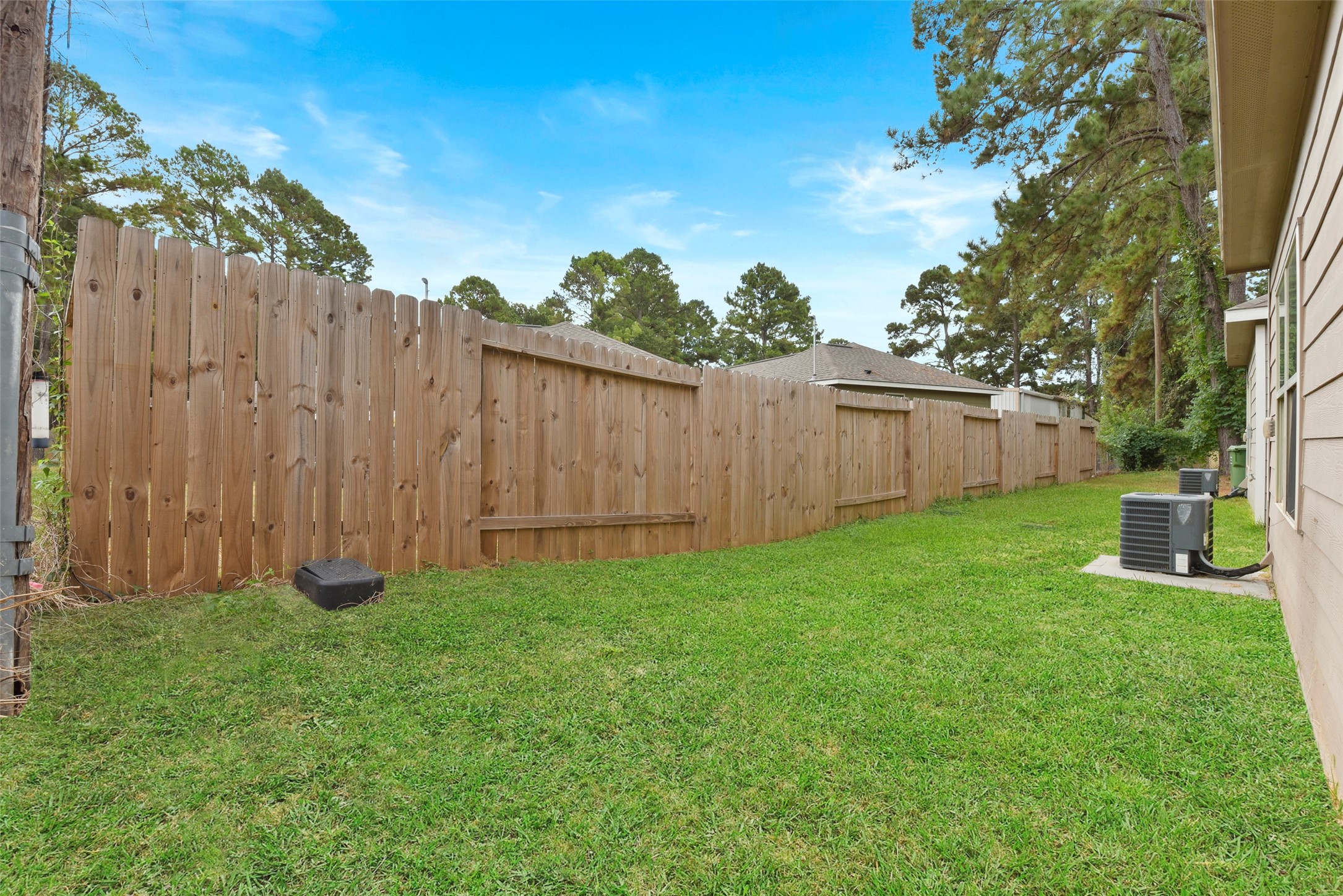 9650 Warm Spring Willis, TX 77318 - Photo 26 of 26 a view of a backyard with a garden