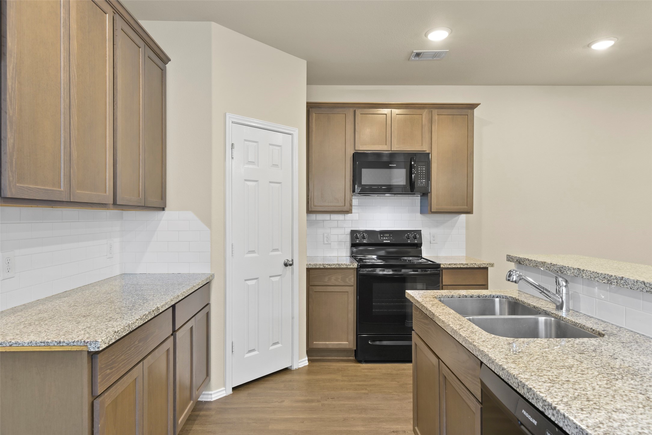 9650 Warm Spring Willis, TX 77318 - Photo 8 of 26 a kitchen with granite countertop a sink stove and refrigerator