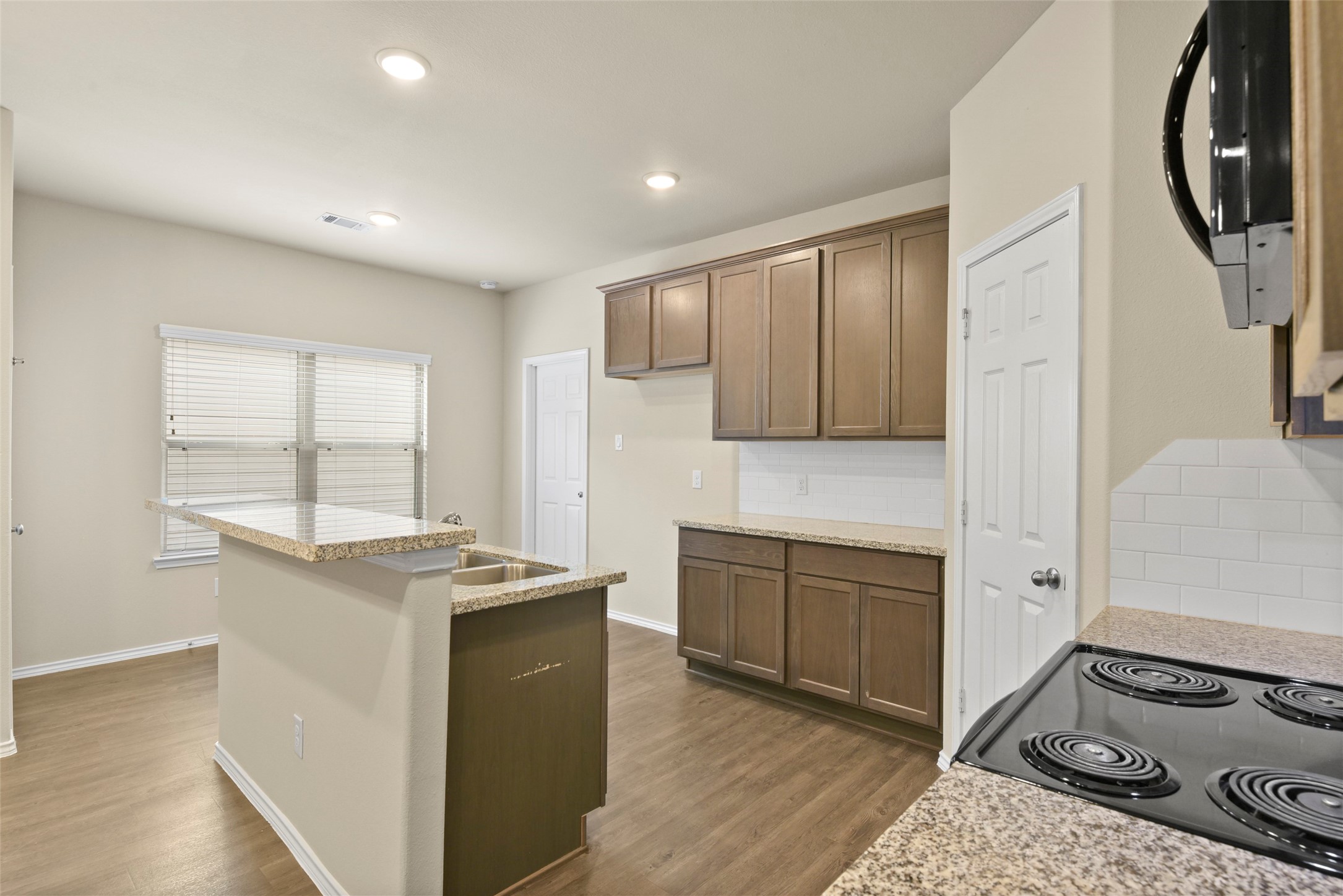 9650 Warm Spring Willis, TX 77318 - Photo 9 of 26 a kitchen with stainless steel appliances granite countertop a stove and a refrigerator