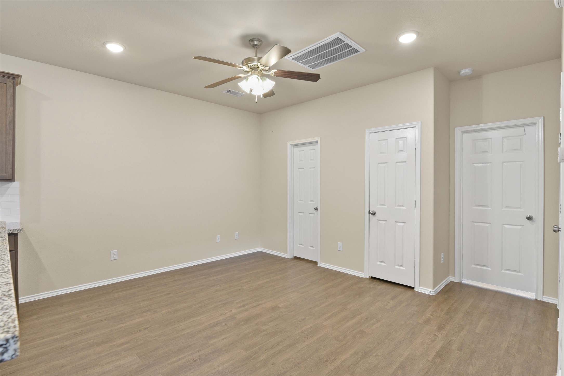 9650 Warm Spring Willis, TX 77318 - Photo 10 of 26 an empty room with wooden floor fan and windows