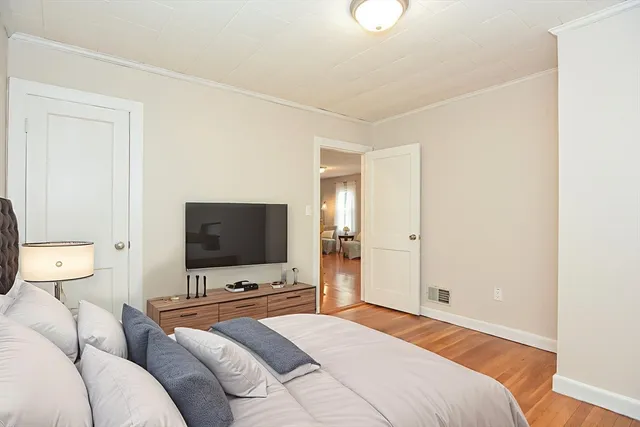 a bedroom with a bed and a flat screen tv