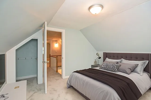 a bedroom with a bed and a painting on the wall