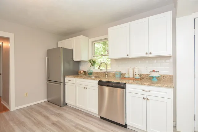 a kitchen with a white cabinets and white appliances
