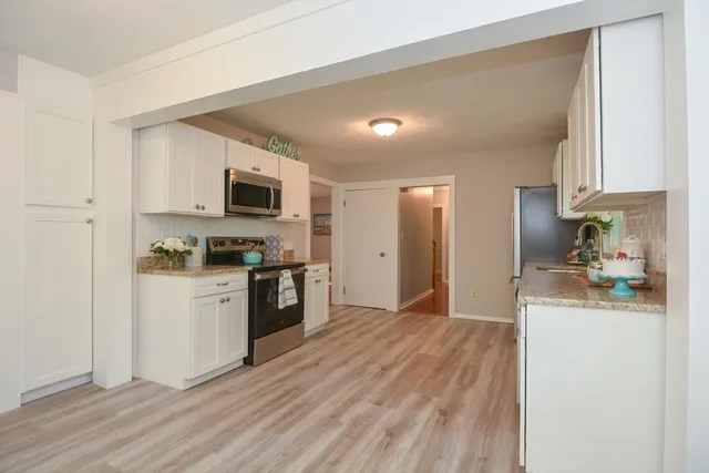 a kitchen with a refrigerator stove and microwave
