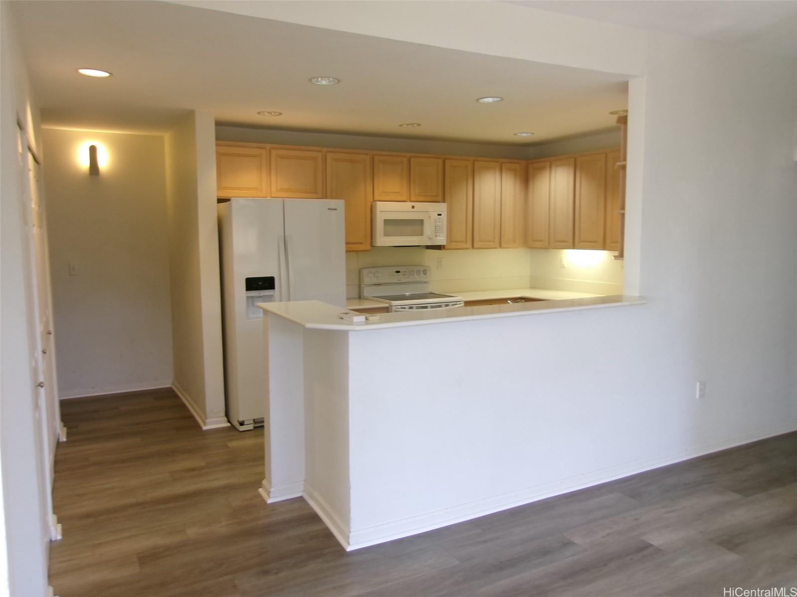 1337 Moanalualani Way, Unit 11H Honolulu, HI 96819 - Photo 2 of 19 a view of a kitchen cabinets and wooden floor