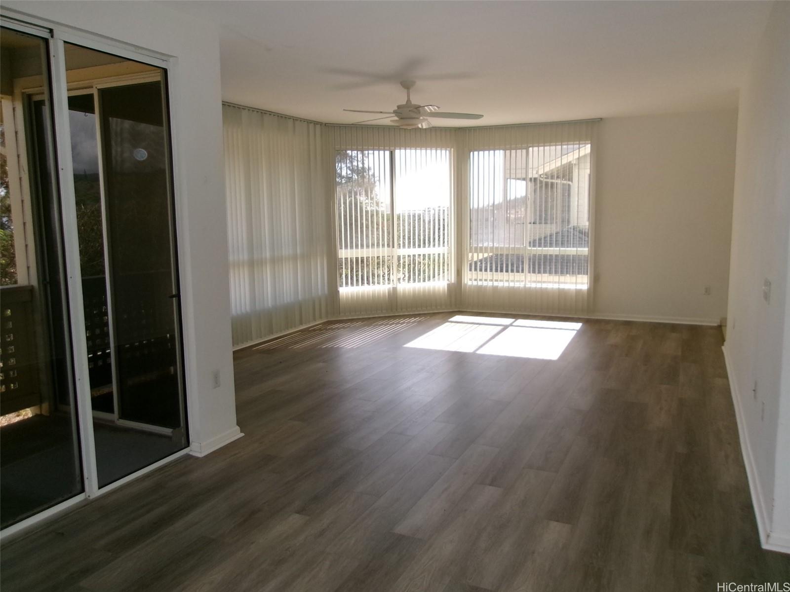 1337 Moanalualani Way, Unit 11H Honolulu, HI 96819 - Photo 3 of 19 a view of empty room with wooden floor and fan