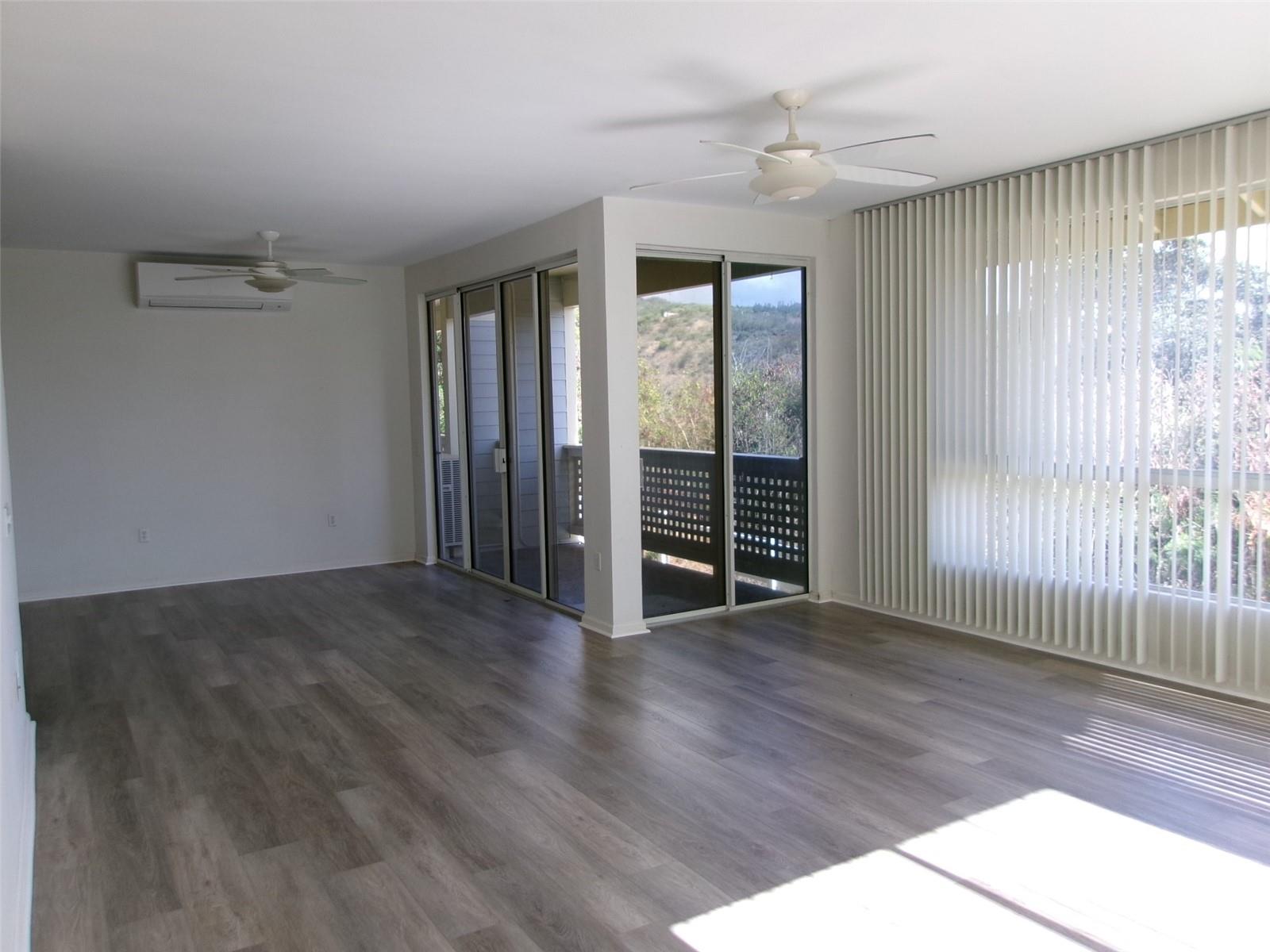 1337 Moanalualani Way, Unit 11H Honolulu, HI 96819 - Photo 4 of 19 an empty room with wooden floor and windows
