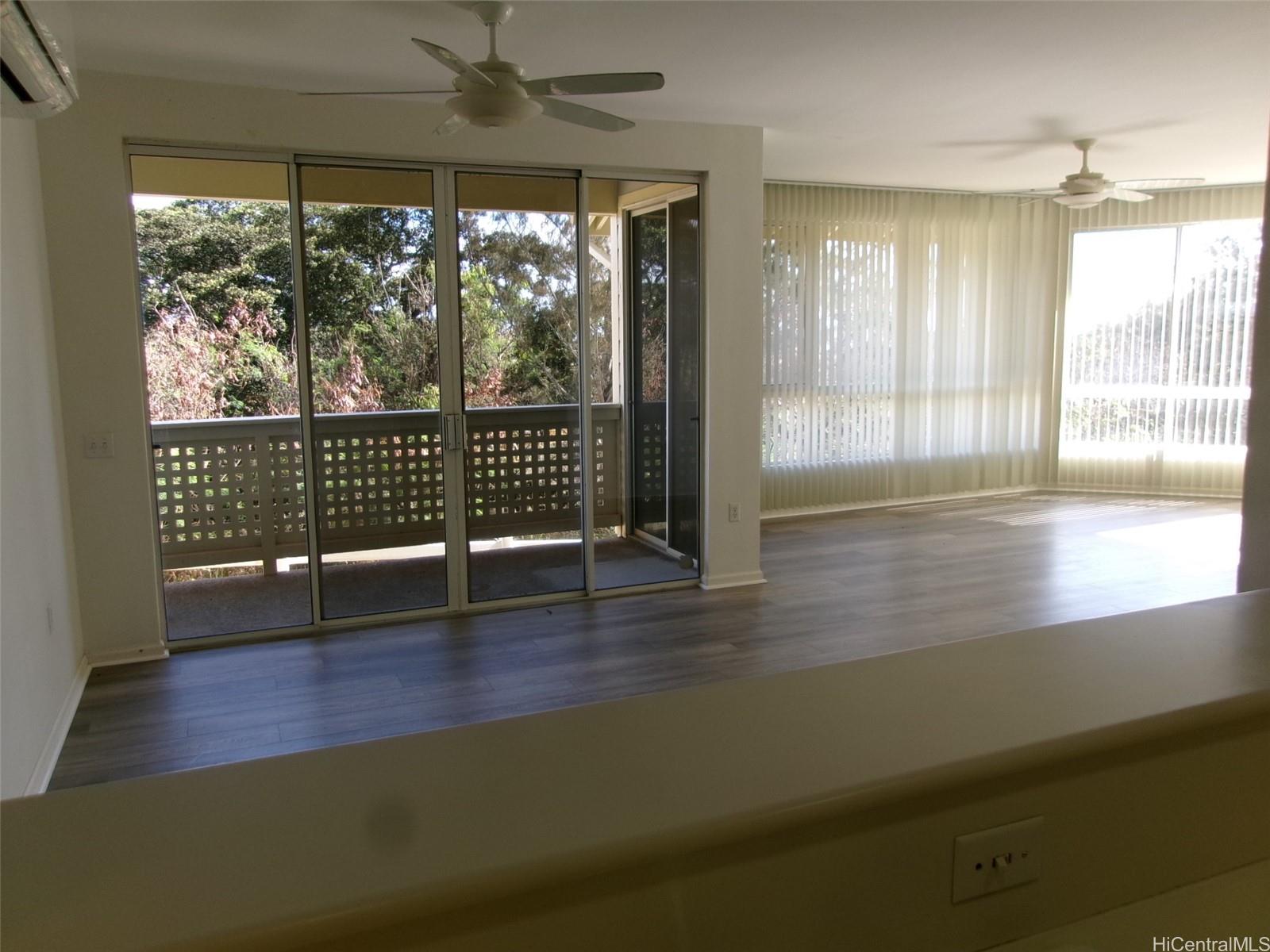 1337 Moanalualani Way, Unit 11H Honolulu, HI 96819 - Photo 5 of 19 a view of empty room with wooden floor and fan
