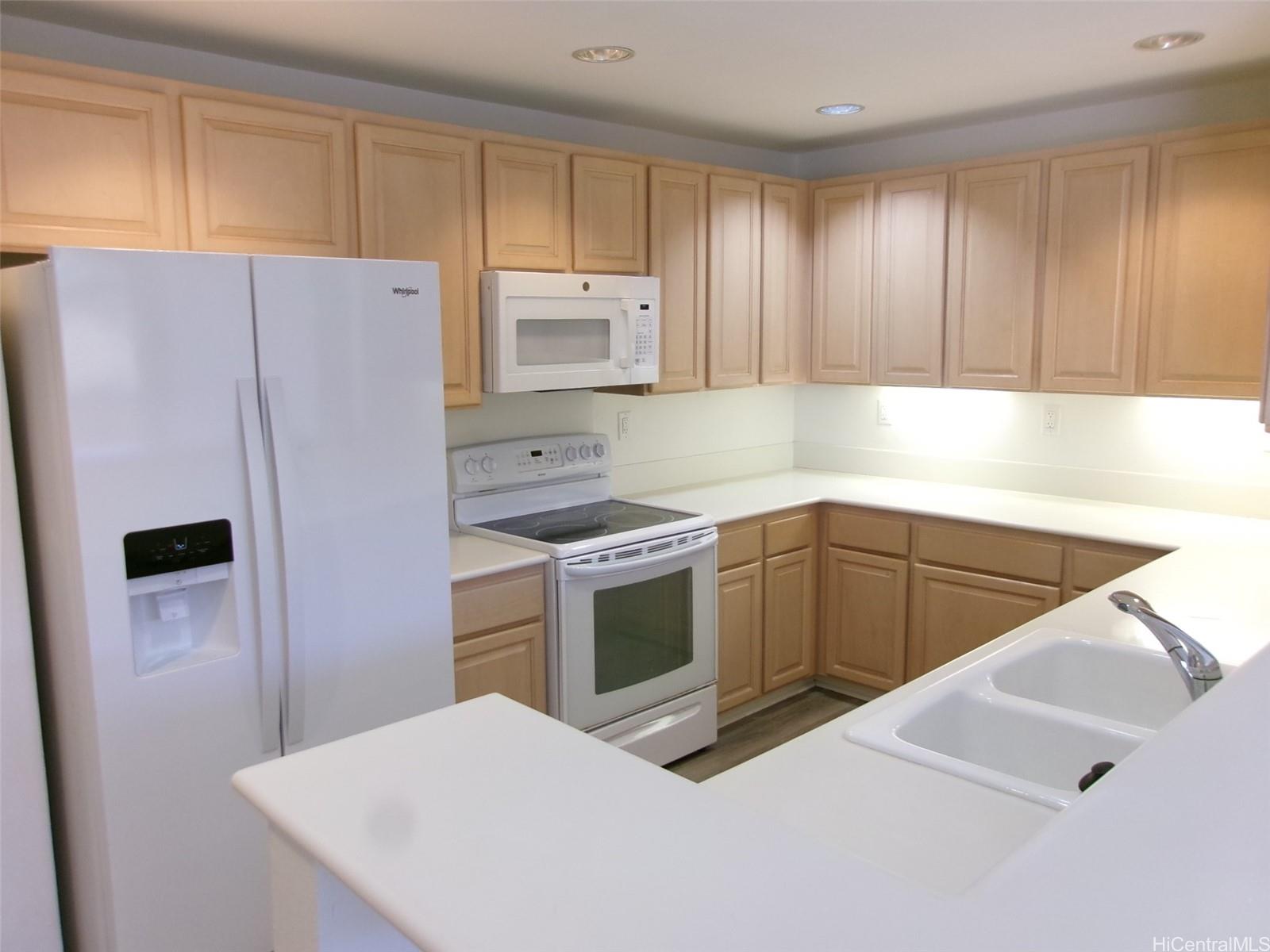 1337 Moanalualani Way, Unit 11H Honolulu, HI 96819 - Photo 6 of 19 a kitchen with a refrigerator sink and cabinets