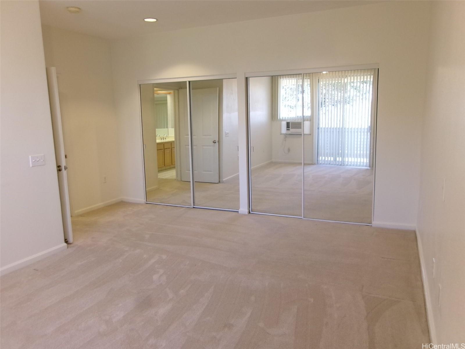 1337 Moanalualani Way, Unit 11H Honolulu, HI 96819 - Photo 9 of 19 an empty room with windows and closet