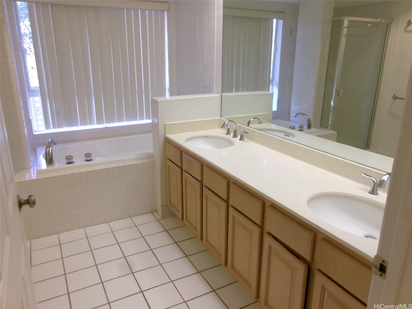 1337 Moanalualani Way, Unit 11H Honolulu, HI 96819 - Photo 10 of 19 a bathroom with a sink vanity and mirror