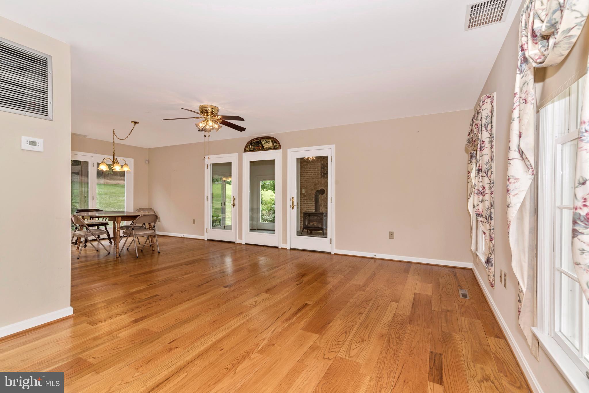 3623 Fry Road Jefferson, MD 21755 - Photo 16 of 30 a view of a room with wooden floor and bench