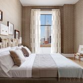 a bedroom with a bed and a chair