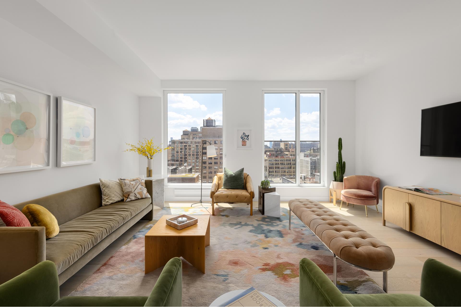 215 West 28th Street, Unit 15C Manhattan, NY 10001 - Photo 1 of 12 a living room with furniture and a flat screen tv