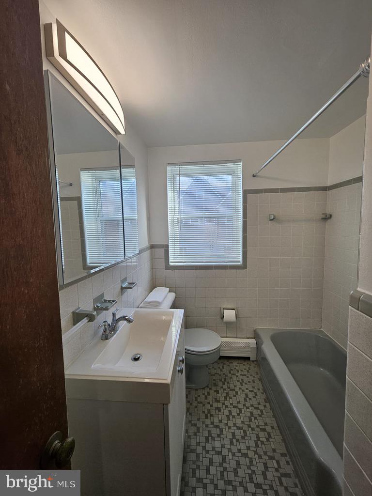 412 North Wayne Avenue, Unit 203 Wayne, PA 19087 - Photo 13 of 21 a bathroom with a sink a toilet and shower