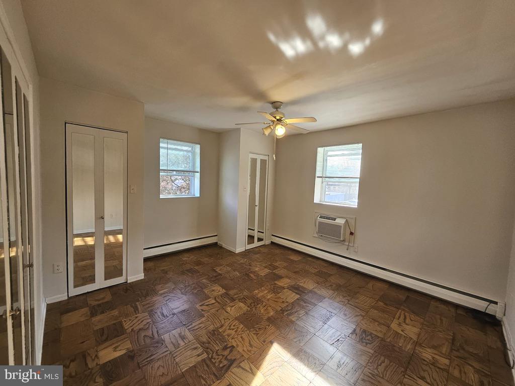 412 North Wayne Avenue, Unit 203 Wayne, PA 19087 - Photo 15 of 21 an empty room with windows and ceiling fan