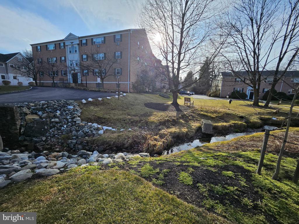 412 North Wayne Avenue, Unit 203 Wayne, PA 19087 - Photo 20 of 21 a view of a house with a yard