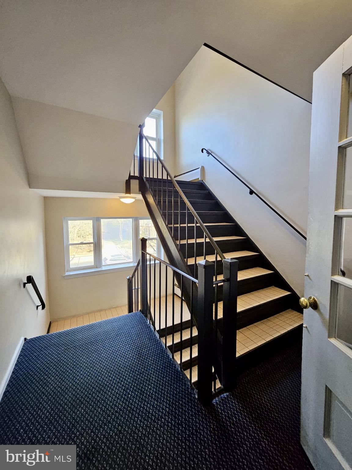 412 North Wayne Avenue, Unit 203 Wayne, PA 19087 - Photo 5 of 21 a bedroom with wooden floor and windows