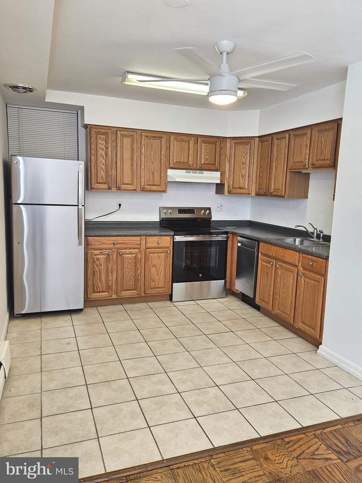 412 North Wayne Avenue, Unit 203 Wayne, PA 19087 - Photo 9 of 21 a kitchen with stainless steel appliances granite countertop a stove a sink and a refrigerator